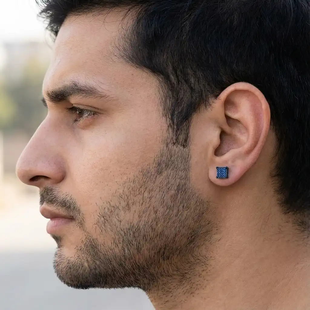 Man wearing square blue diamond stud earring in blue plated sterling silver
