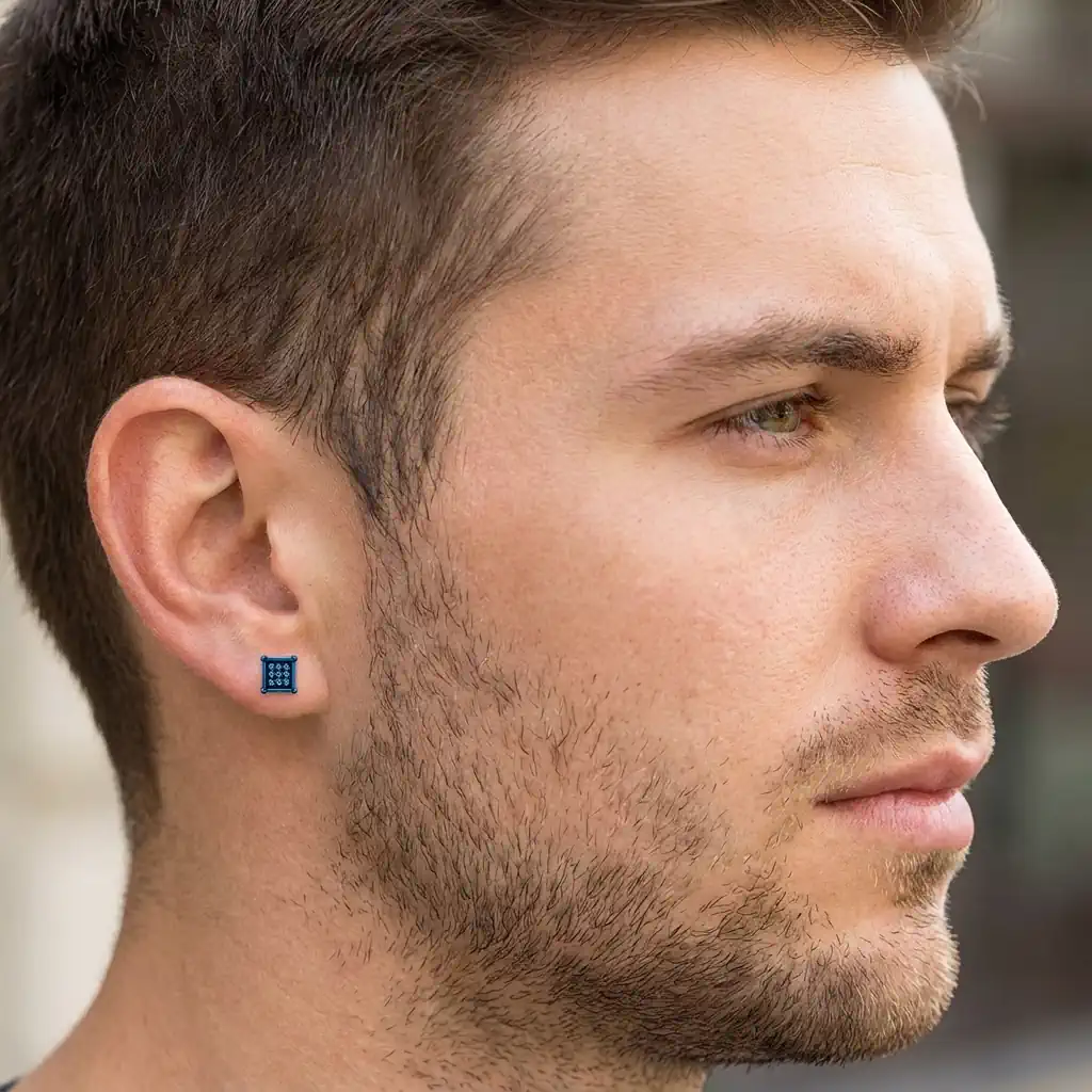 Man wearing square hip hop diamond stud earring in sterling silver with blue or black diamonds