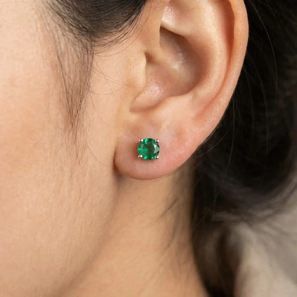 woman wearing 5.5mm round lab created gemstone solitaire stud earrings