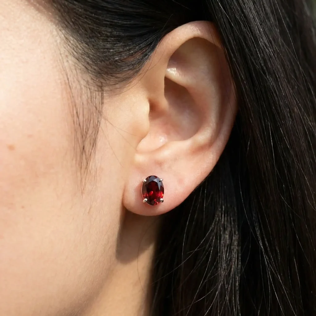 woman wearing 6x4mm oval gemstone solitaire stud earrings