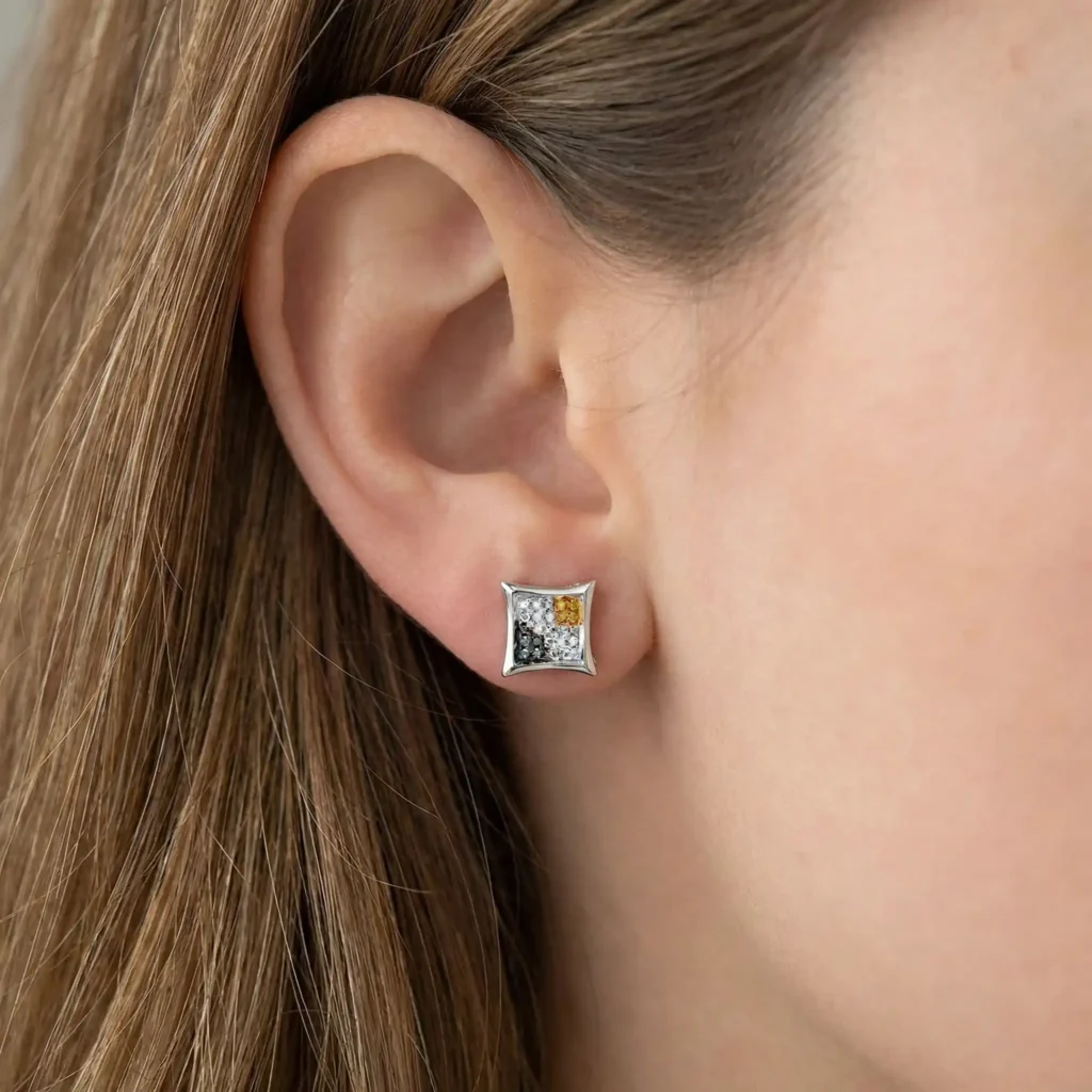woman wearing blue, white, and yellow diamond micro-pavé kite-shape hip hop stud earrings