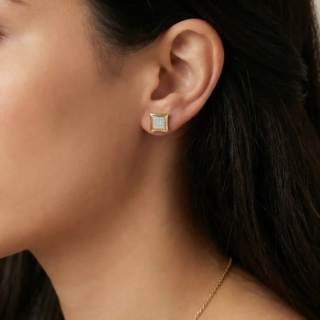 woman wearing round white diamond kite-shape hip hop iced-out stud earrings