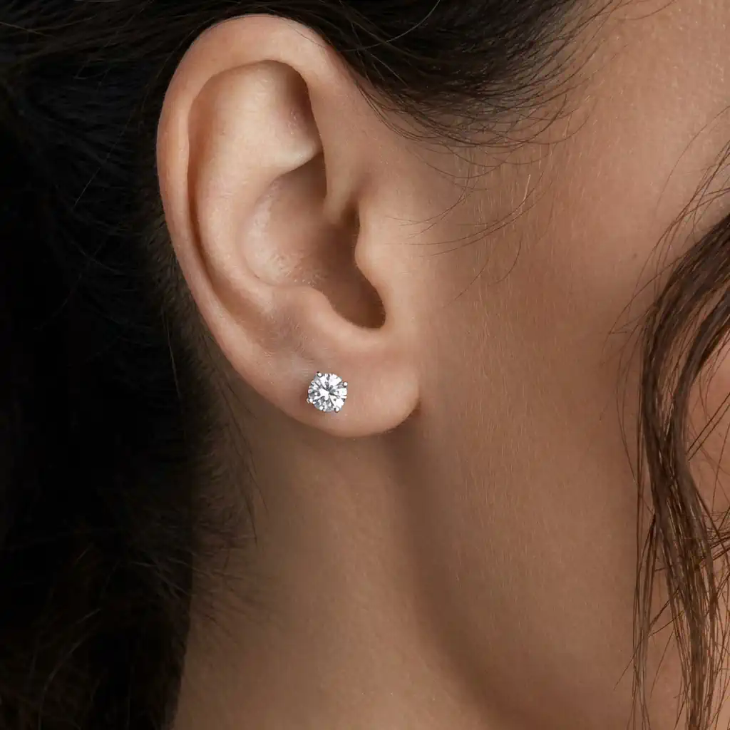 Woman wearing lab grown diamond stud earrings 14K gold screw back elegant diamond studs
