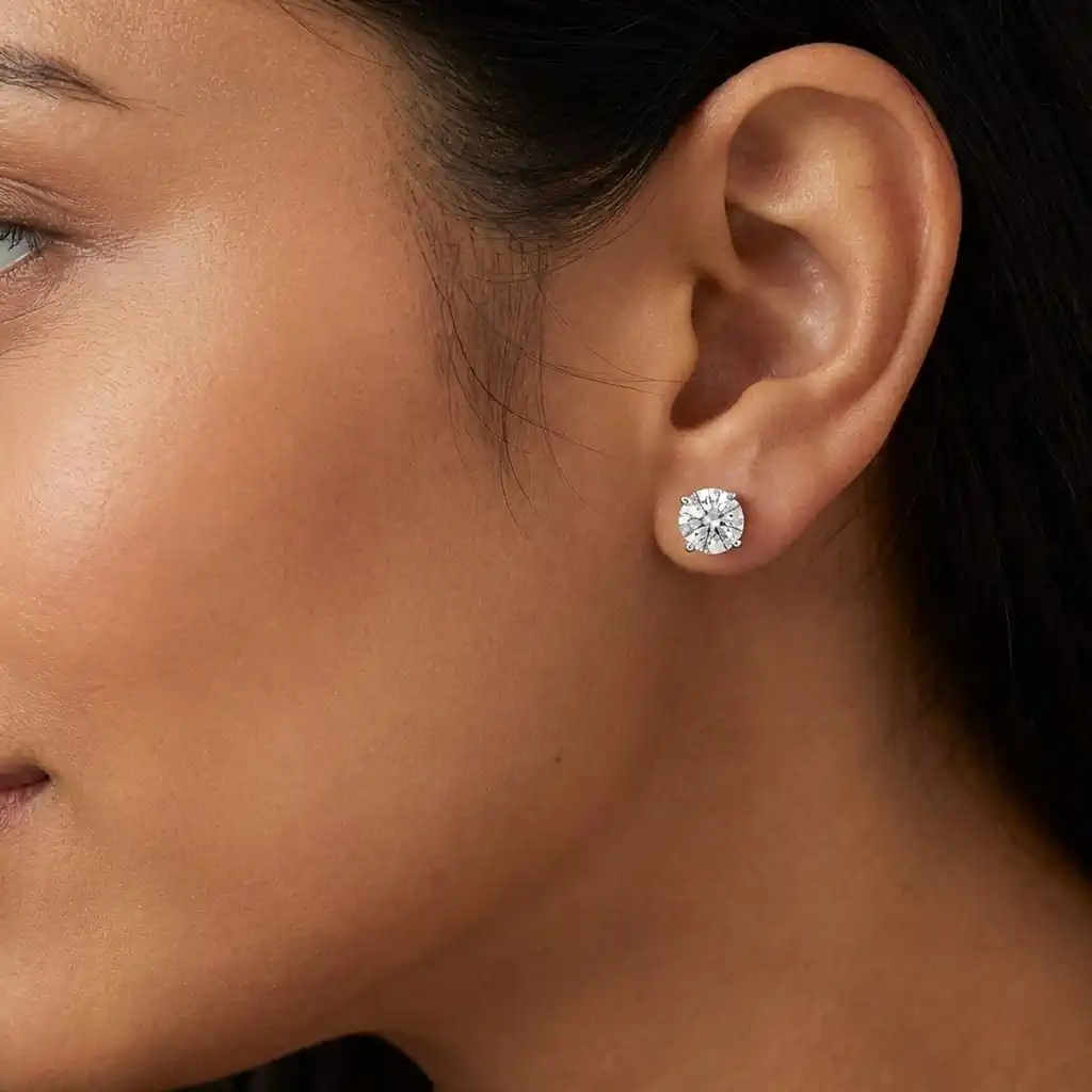 Woman wearing Houston Diamond District lab grown diamond stud earrings 14K gold round cut