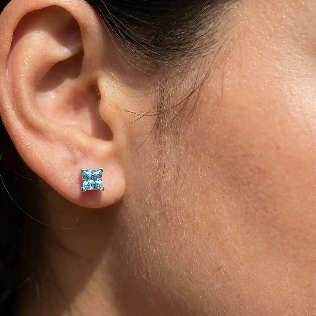 Woman wearing princess cut lab grown diamond stud earrings 14K white gold square studs